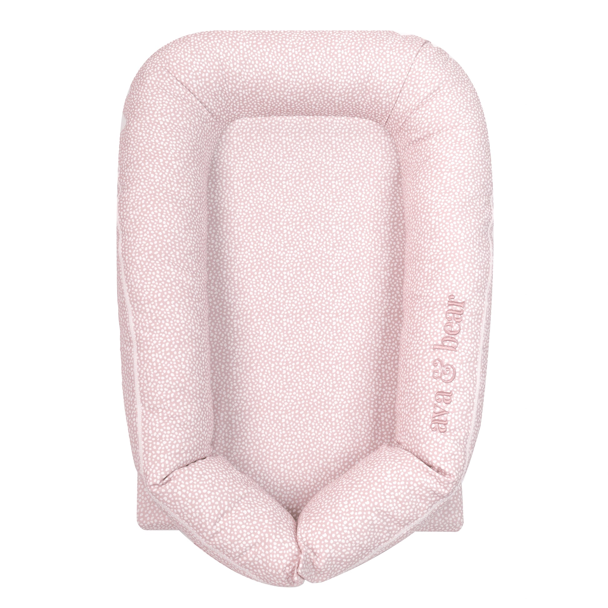 Ava & Bear Pink Spot Lounging Pod nestled in a cozy setting, showcasing its plush Cotton Twill fabric and waterproof base, ideal for tummy-time and play; complete with a carry bag for on-the-go convenience.